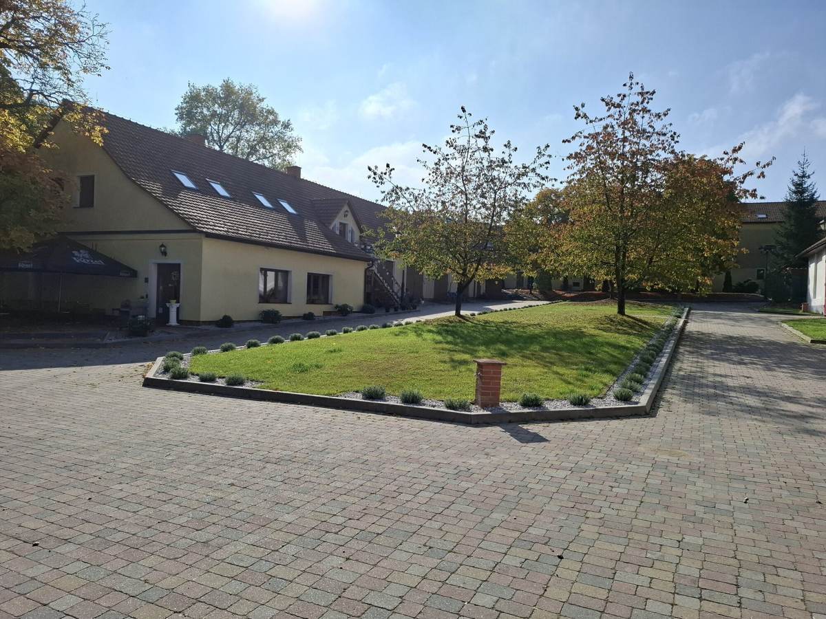 Farm courtyard with lawn and the guest house